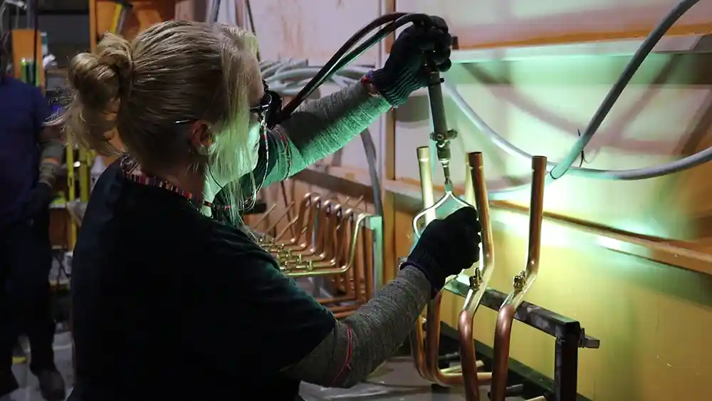 Woman using a torch for brazing